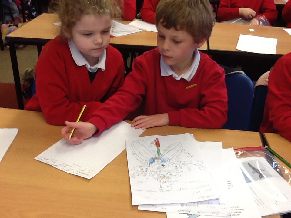 Children sat at the table working on their drawing design.